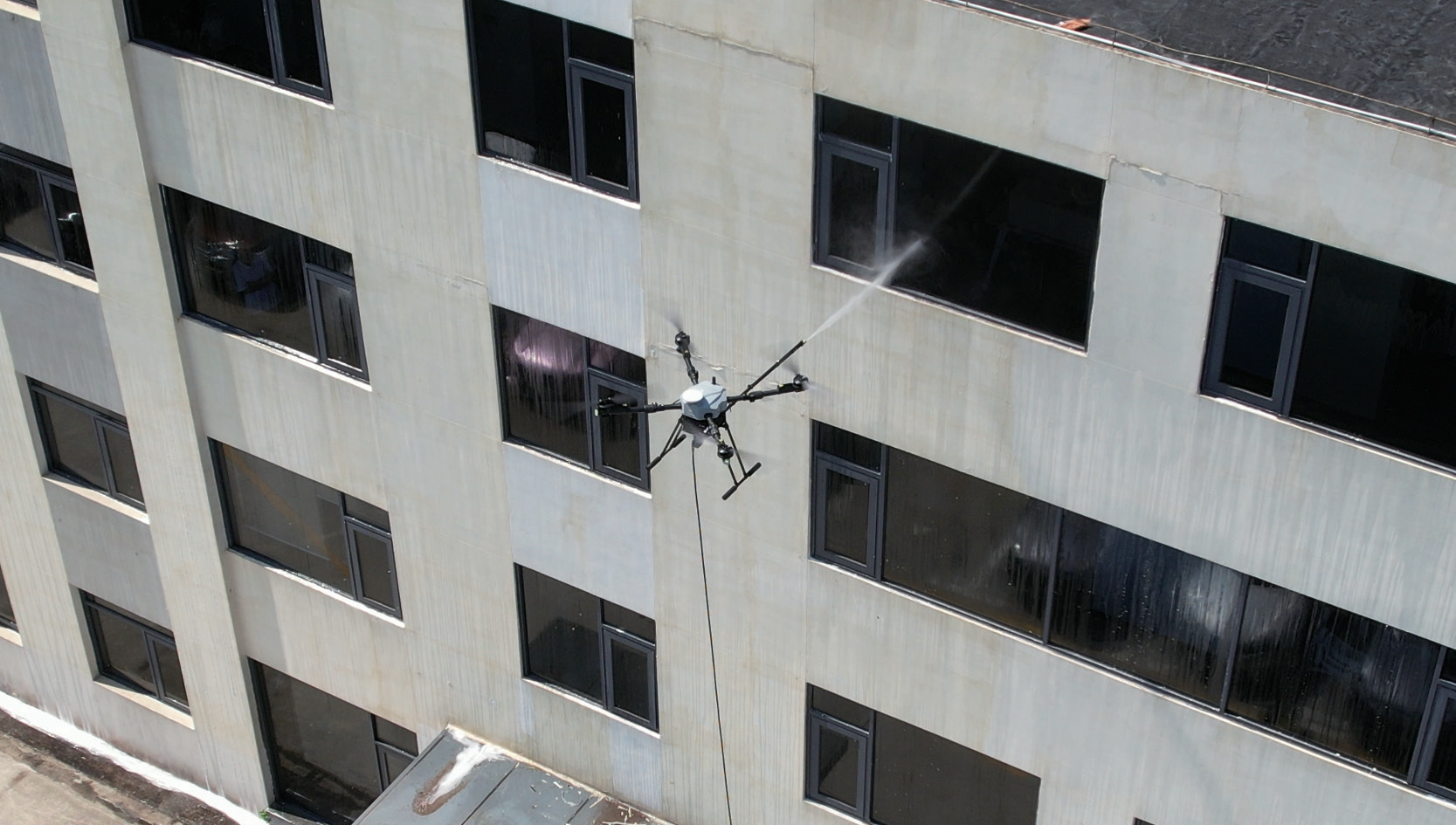 D15R cleaning a building facade at height